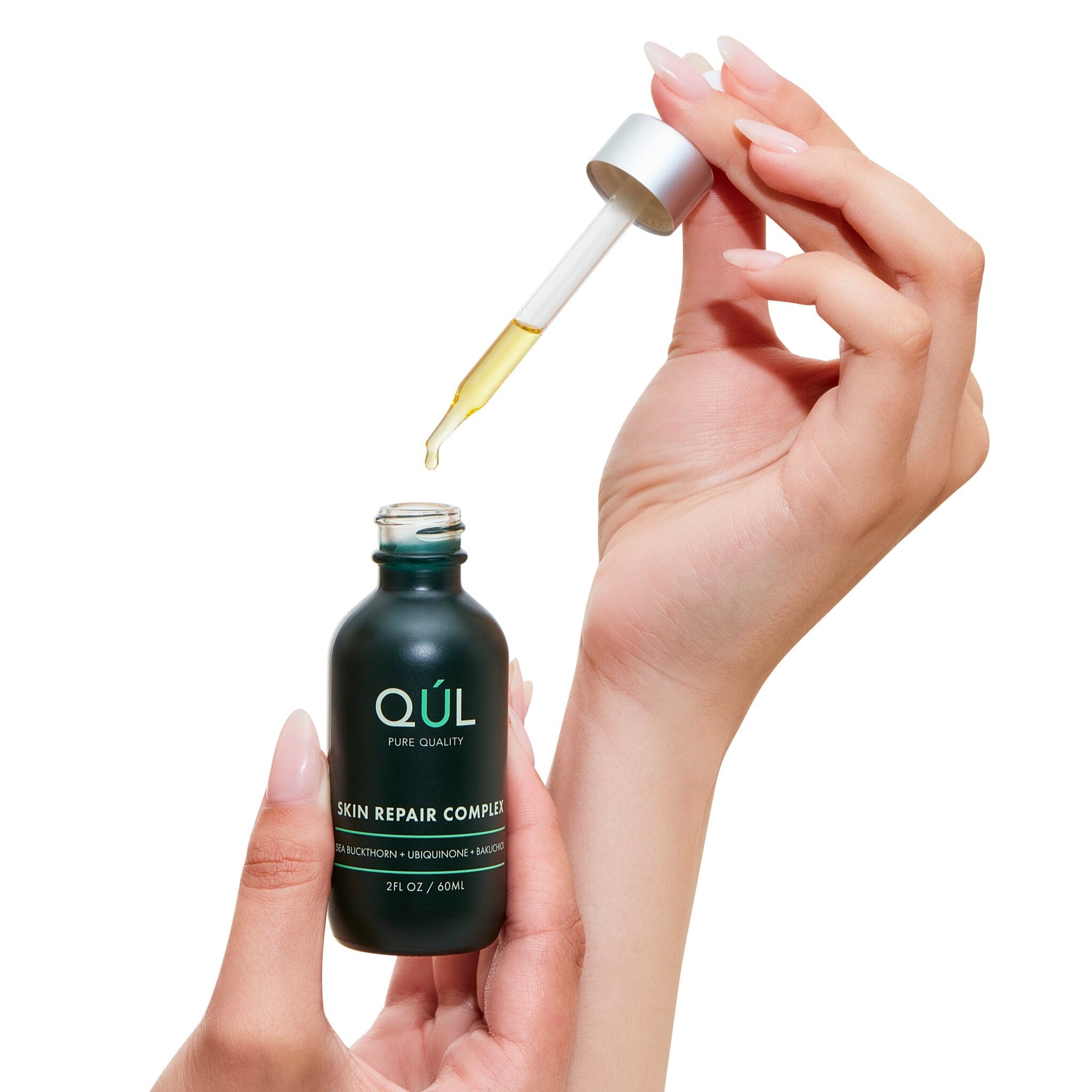 QUL Beauty Skin Repair Complex Bottle with Model's Hands and Dropper
