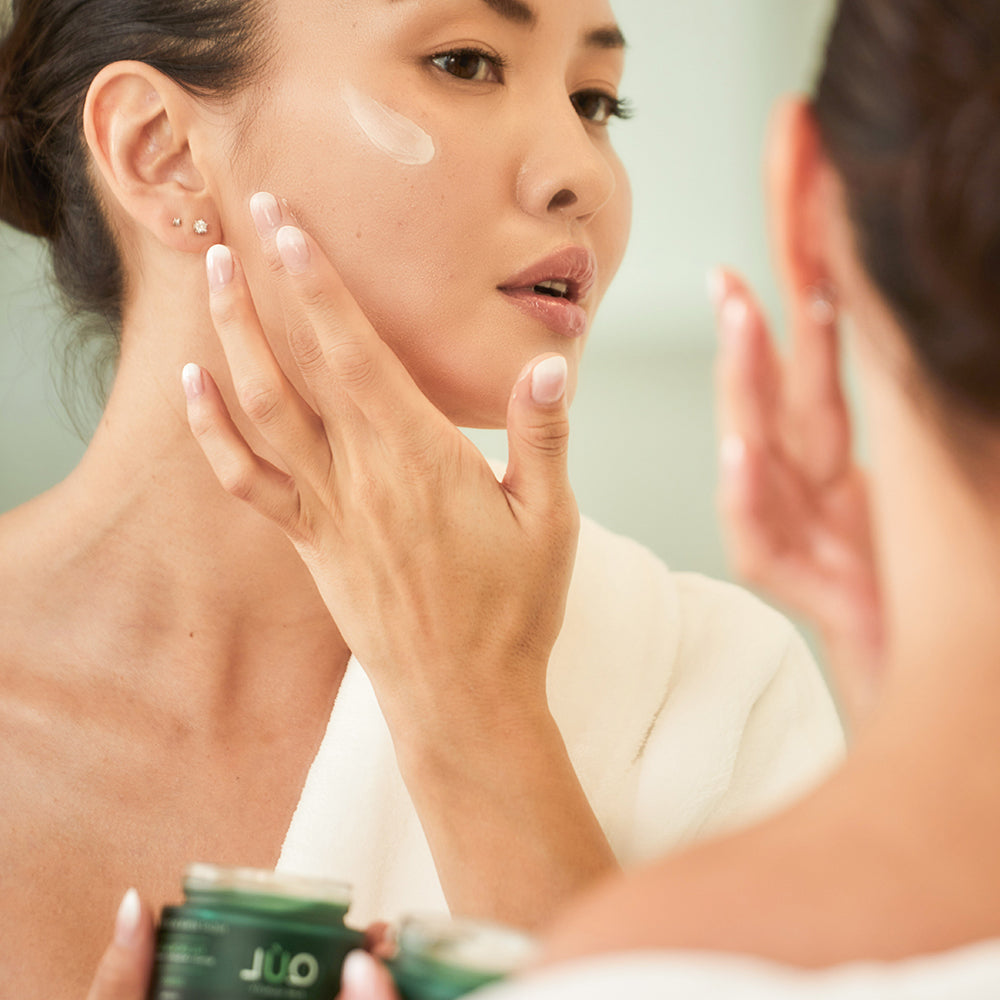 QUL Night Repair Moisturizer model applying cream